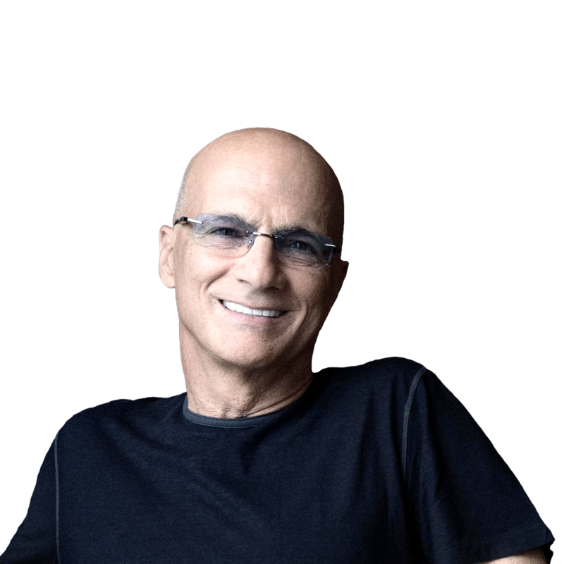 Jimmy Iovine wearing a dark T-shirt and glasses while smiling.